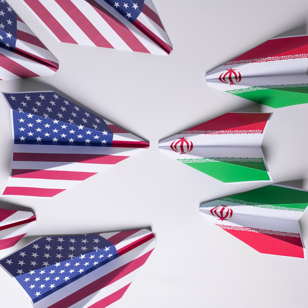 Paper airplanes with the US and Iranian flags face each other