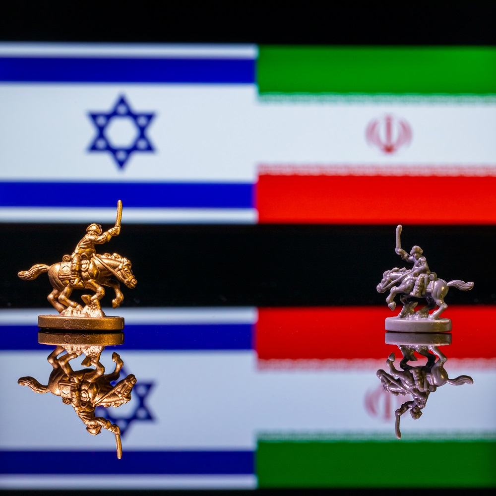 Two equestrian figures in front of the flags of Iran and Israel.